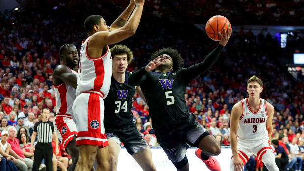 Washington Huskies guard Sahvir Wheeler (5) shoots a basket against Arizona Wildcats forward Keshad Johnson (16) during the first half at McKale Center.